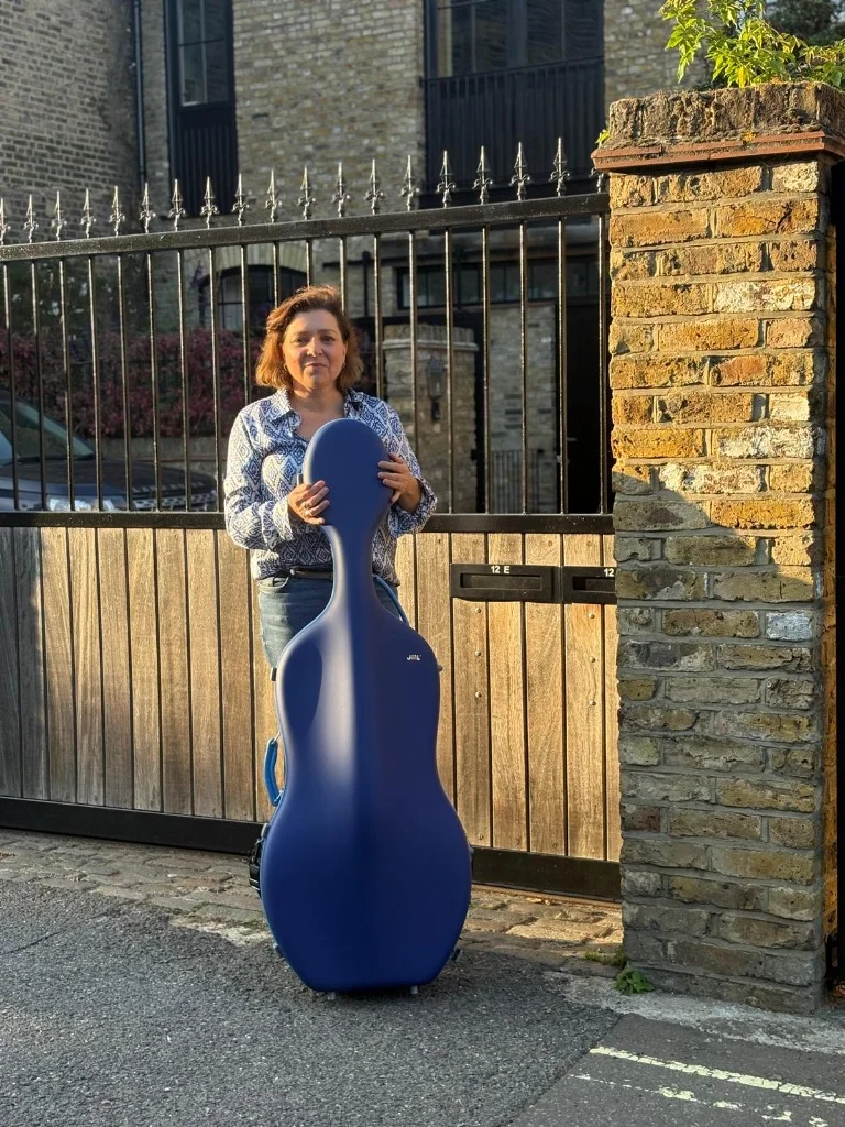 Josephine Knight, Global Collaborating Artist for JML, with her navy blue cello case